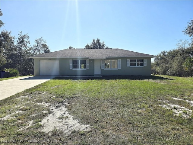 single story home featuring a garage and a front lawn