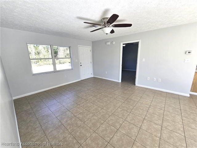 tiled spare room with ceiling fan and a textured ceiling