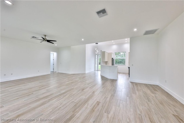 unfurnished living room featuring ceiling fan and light hardwood / wood-style flooring