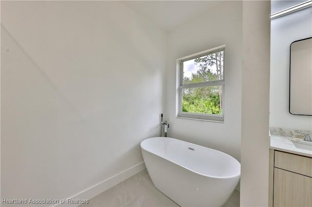 bathroom featuring a tub to relax in and vanity