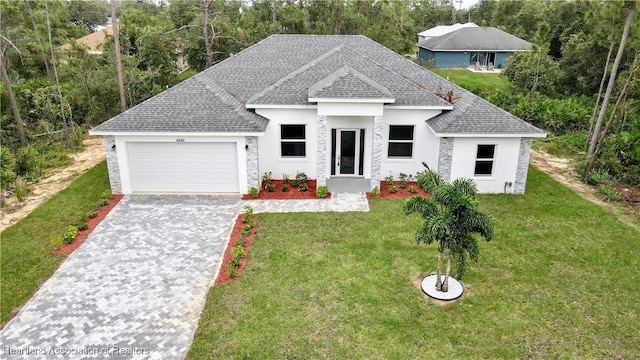 view of front of property with a front yard and a garage