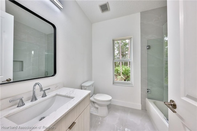 full bathroom with tile patterned flooring, enclosed tub / shower combo, a textured ceiling, toilet, and vanity