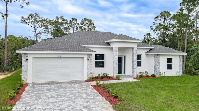 view of front of property featuring a garage and a front lawn