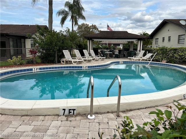 pool with fence and a gazebo