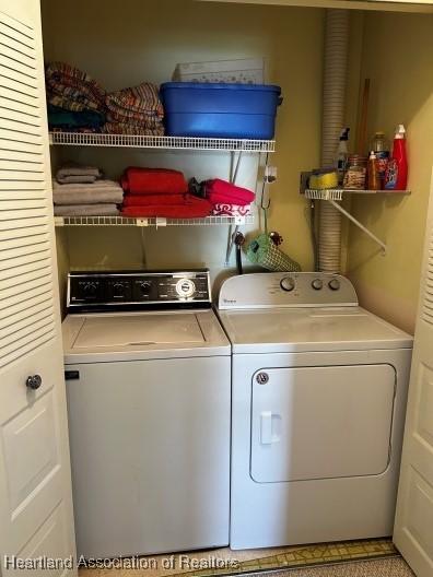 washroom with washing machine and dryer and laundry area