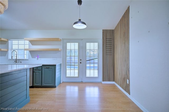 33064 Grand Prix Dr, Sebring, FL 33872 - kitchen with open shelves, french doors, light wood finished floors, and light countertops