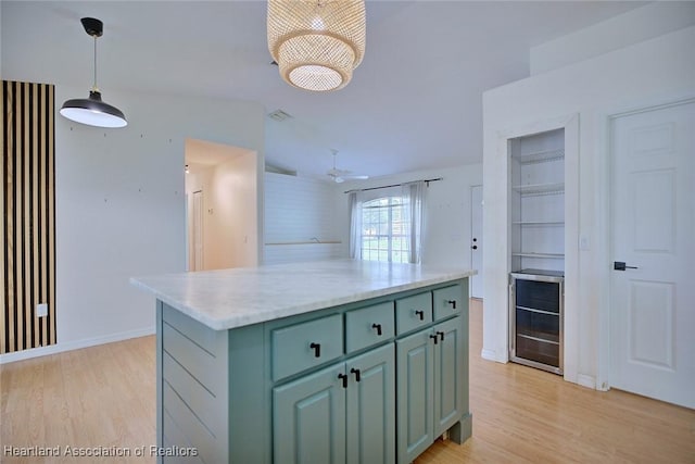 33064 Grand Prix Dr, Sebring, FL 33872 - kitchen featuring light wood-type flooring, green cabinetry, decorative light fixtures, and baseboards