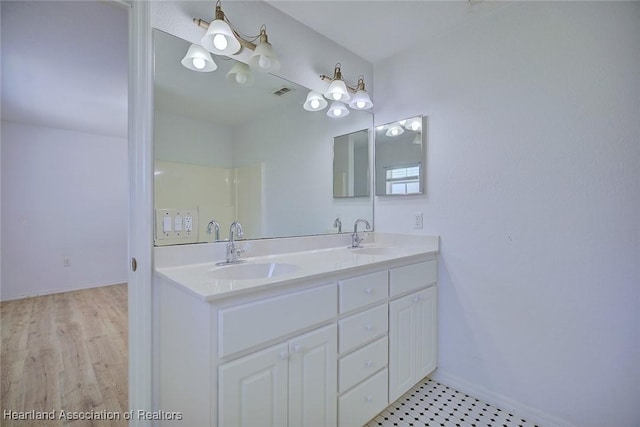 33064 Grand Prix Dr, Sebring, FL 33872 - bathroom featuring double vanity and baseboards
