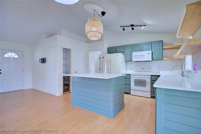 33064 Grand Prix Dr, Sebring, FL 33872 - kitchen with white appliances, a sink, lofted ceiling, light countertops, and light wood-style flooring
