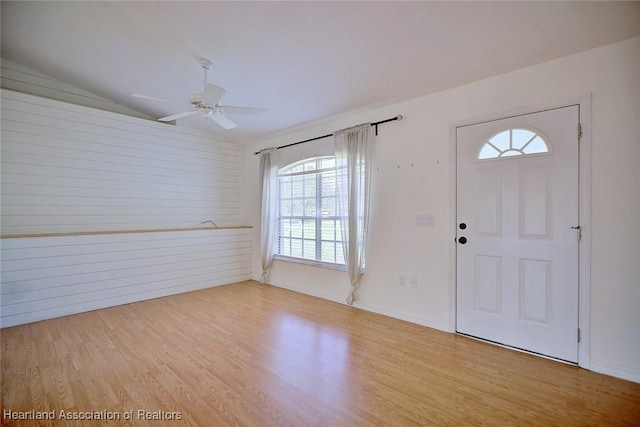 33064 Grand Prix Dr, Sebring, FL 33872 - foyer entrance featuring healthy amount of natural light, wood finished floors, ceiling fan, lofted ceiling, and wood walls