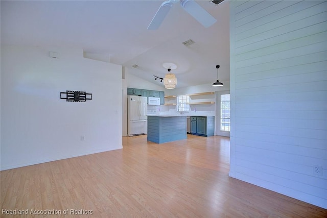 33064 Grand Prix Dr, Sebring, FL 33872 - unfurnished living room with light wood-style floors, a ceiling fan, and vaulted ceiling