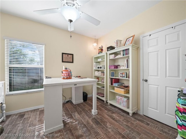 home office featuring dark wood-type flooring, a ceiling fan, and baseboards