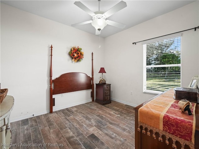 bedroom with a ceiling fan, baseboards, and wood finished floors