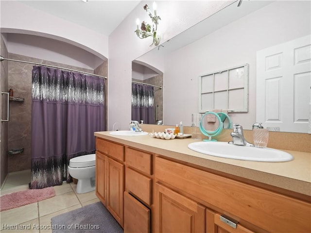 full bathroom with a shower with shower curtain, a sink, and tile patterned floors