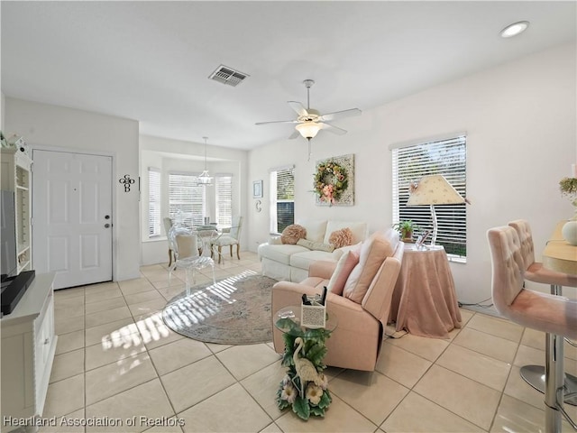 living room with a ceiling fan, recessed lighting, visible vents, and light tile patterned floors