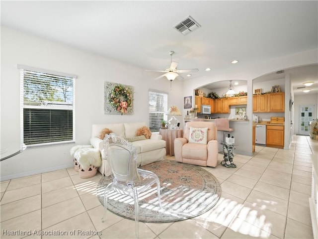 living area featuring a wealth of natural light, visible vents, recessed lighting, and light tile patterned flooring