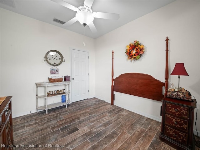 interior space featuring a ceiling fan, visible vents, and wood finished floors