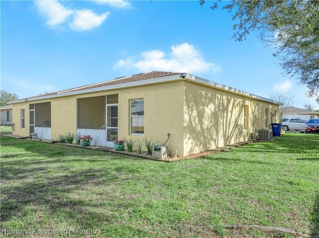 view of property exterior with cooling unit, a lawn, and stucco siding