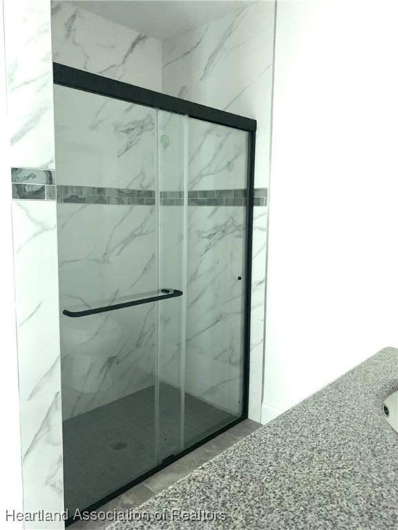 bathroom with an enclosed shower