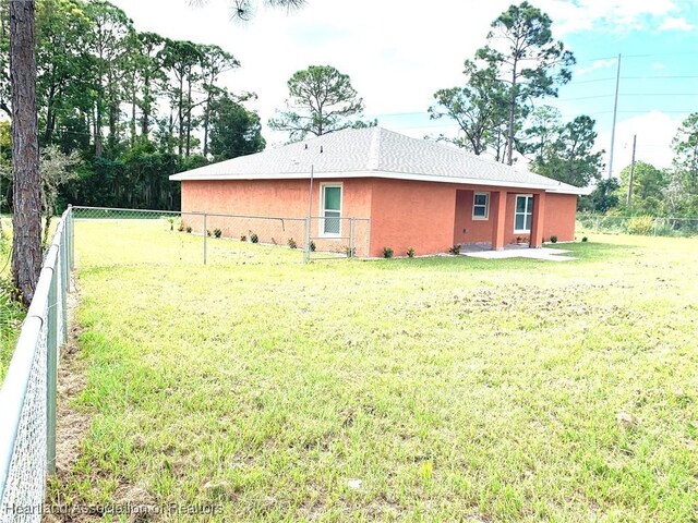 back of house with a yard