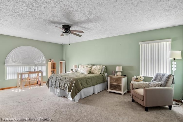 bedroom with light colored carpet, ceiling fan, a textured ceiling, and baseboards