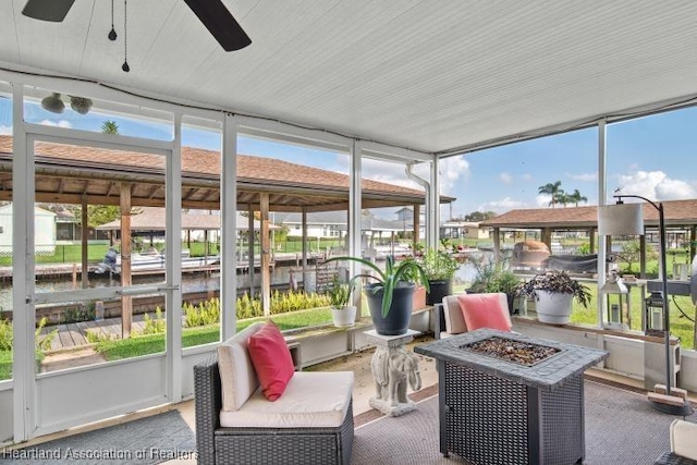 sunroom / solarium featuring ceiling fan