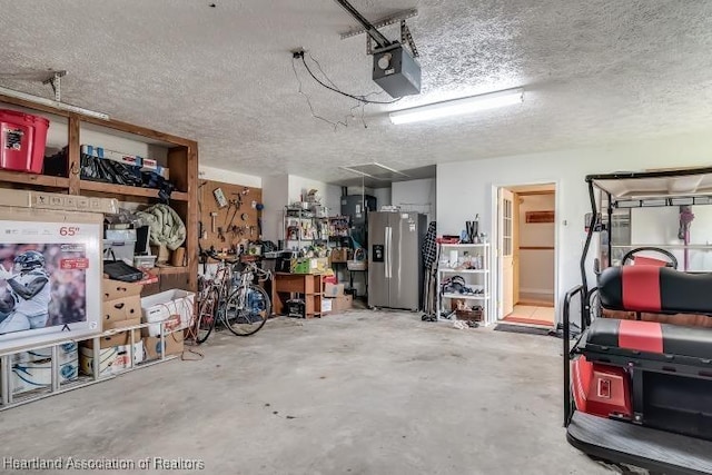 garage featuring a workshop area, stainless steel fridge, and a garage door opener