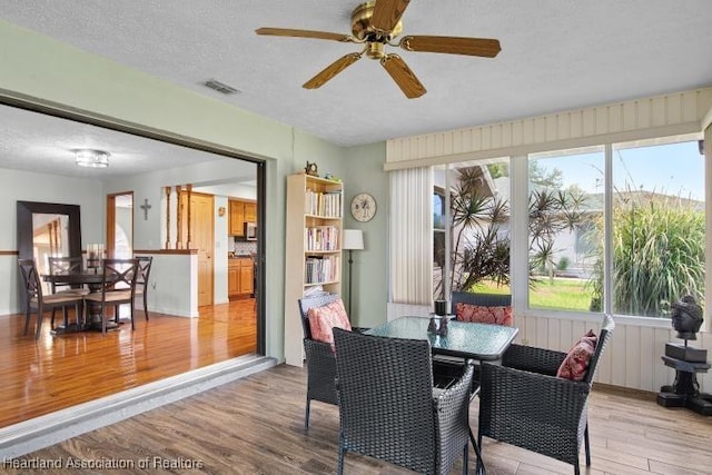 sunroom with visible vents and a ceiling fan