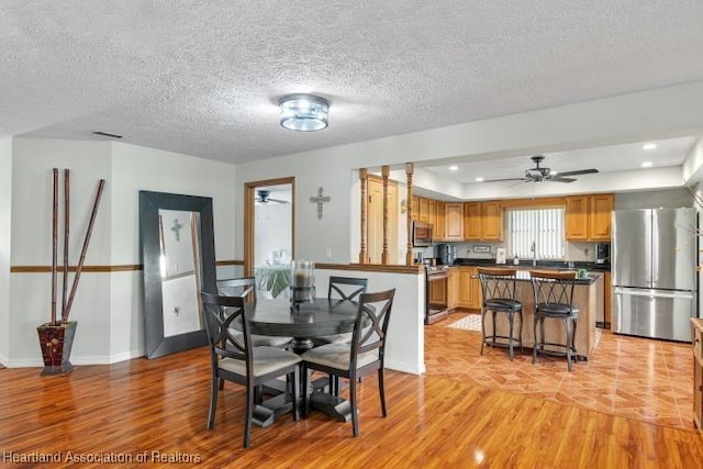 dining room with light wood-style floors, recessed lighting, ceiling fan, and baseboards