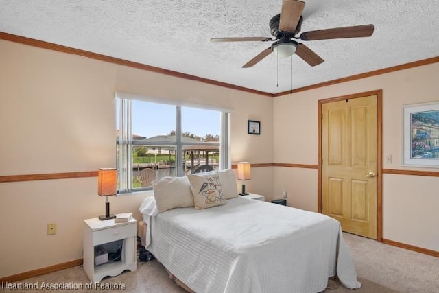 bedroom with ornamental molding, a textured ceiling, and light colored carpet