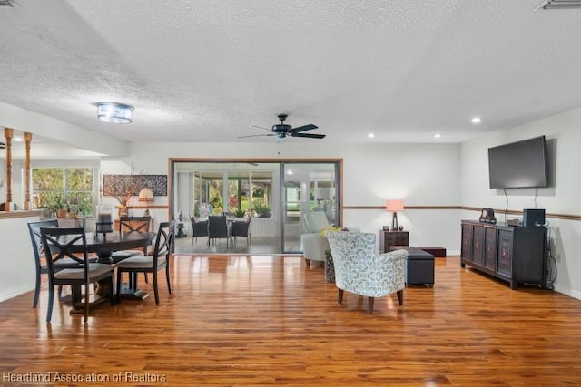 interior space with recessed lighting, ceiling fan, a textured ceiling, wood finished floors, and baseboards