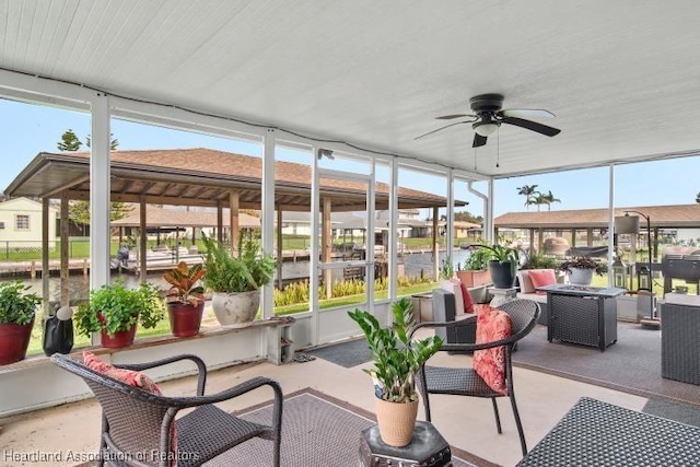 sunroom / solarium featuring ceiling fan and a wealth of natural light