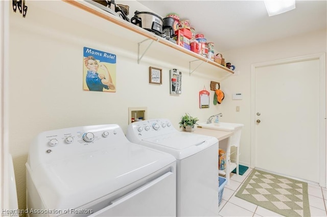 laundry room featuring washing machine and clothes dryer and light tile patterned flooring