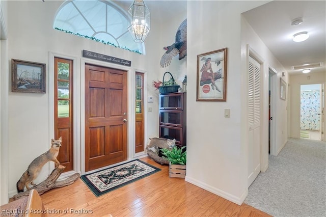 entryway with a chandelier and hardwood / wood-style floors