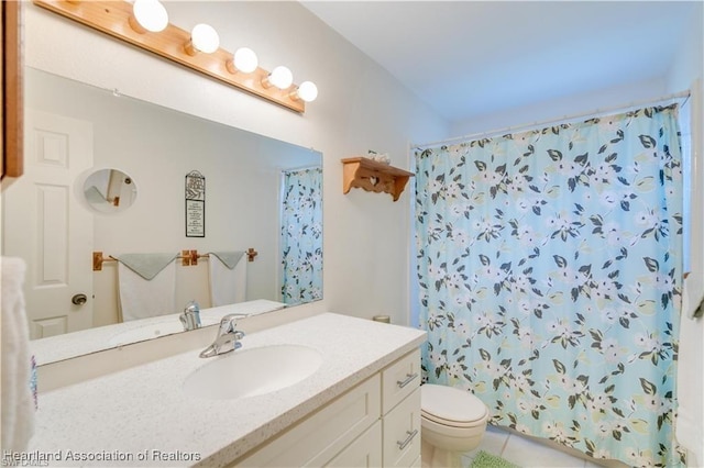 bathroom featuring walk in shower, tile patterned floors, vanity, and toilet