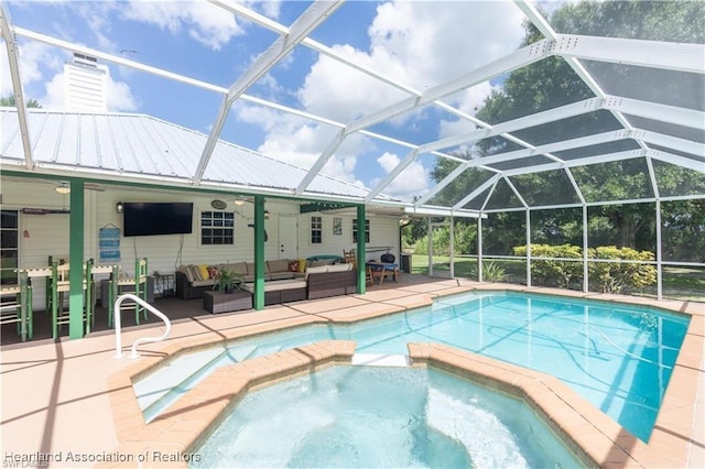 view of pool featuring a lanai, outdoor lounge area, an in ground hot tub, and a patio