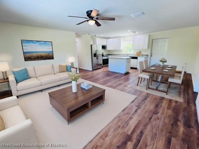 1100 Redbird St, Lake Placid, FL 33852 - living area with wood finished floors, ceiling fan, and baseboards