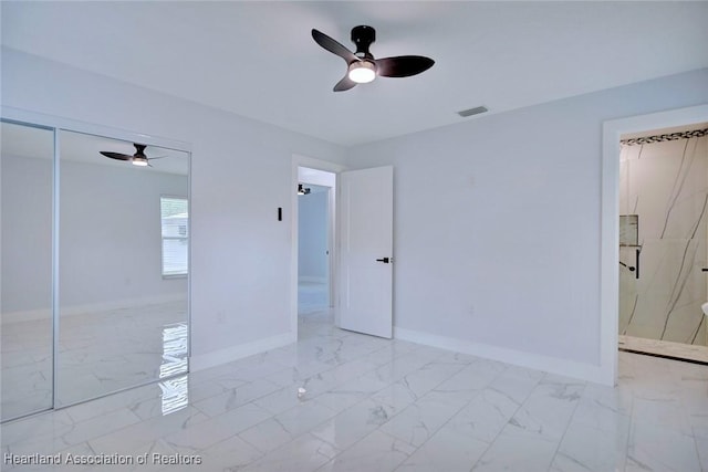 unfurnished bedroom featuring ceiling fan and a closet