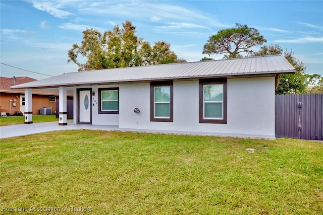 ranch-style house with cooling unit and a front yard