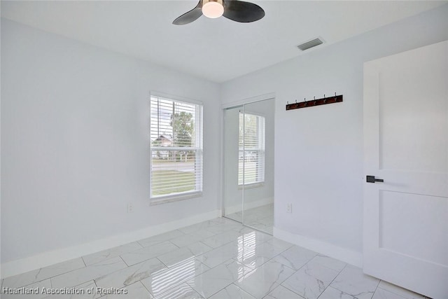 unfurnished room with ceiling fan