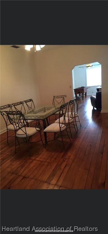 unfurnished dining area featuring ceiling fan and dark hardwood / wood-style flooring