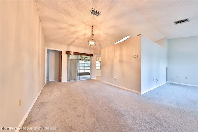 232 Dove Ave, Sebring, FL 33870 - empty room featuring carpet floors, baseboards, a chandelier, vaulted ceiling, and a textured ceiling