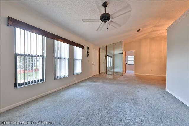 232 Dove Ave, Sebring, FL 33870 - carpeted spare room featuring a ceiling fan, baseboards, and vaulted ceiling