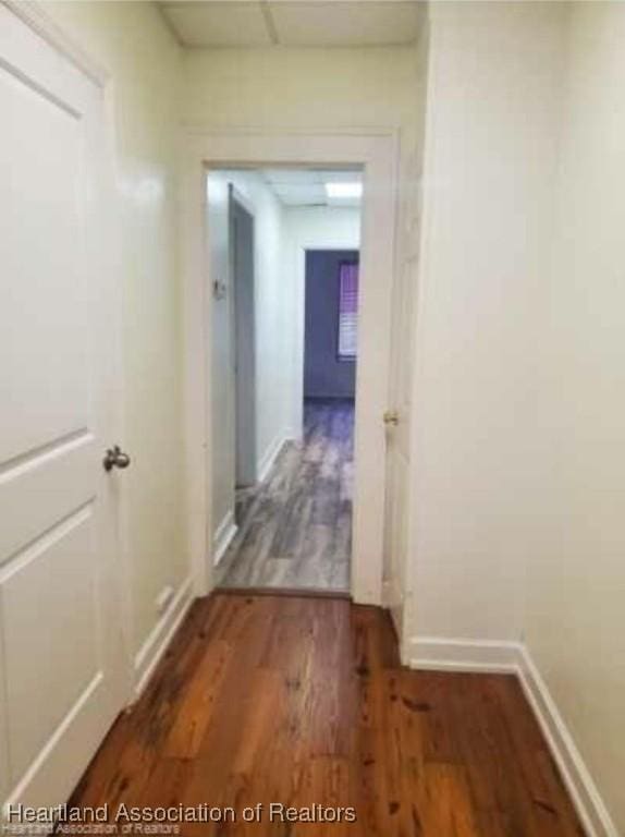 corridor featuring dark hardwood / wood-style flooring