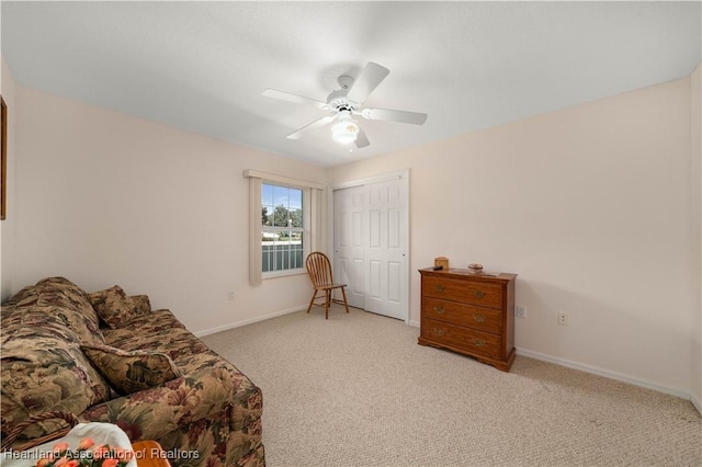 sitting room featuring ceiling fan and light colored carpet