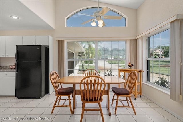 dining room with ceiling fan, a healthy amount of sunlight, and light tile patterned floors