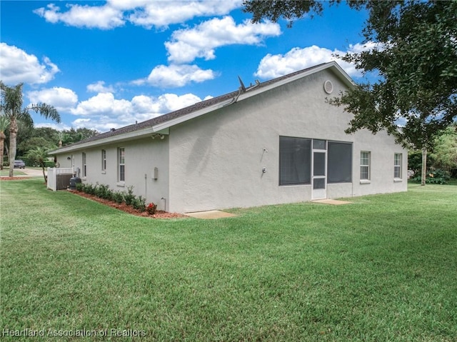 rear view of property featuring a yard