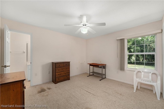 miscellaneous room with ceiling fan and light carpet