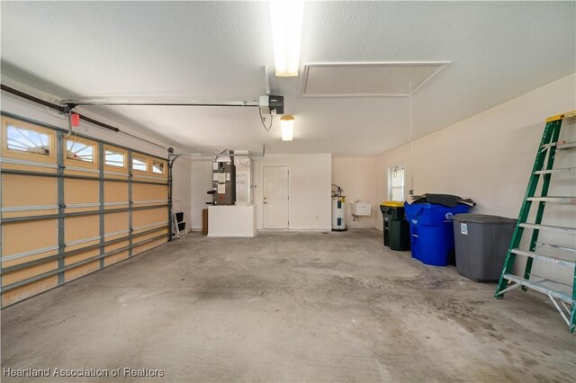 garage with a garage door opener and water heater