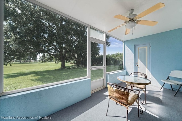 sunroom featuring ceiling fan